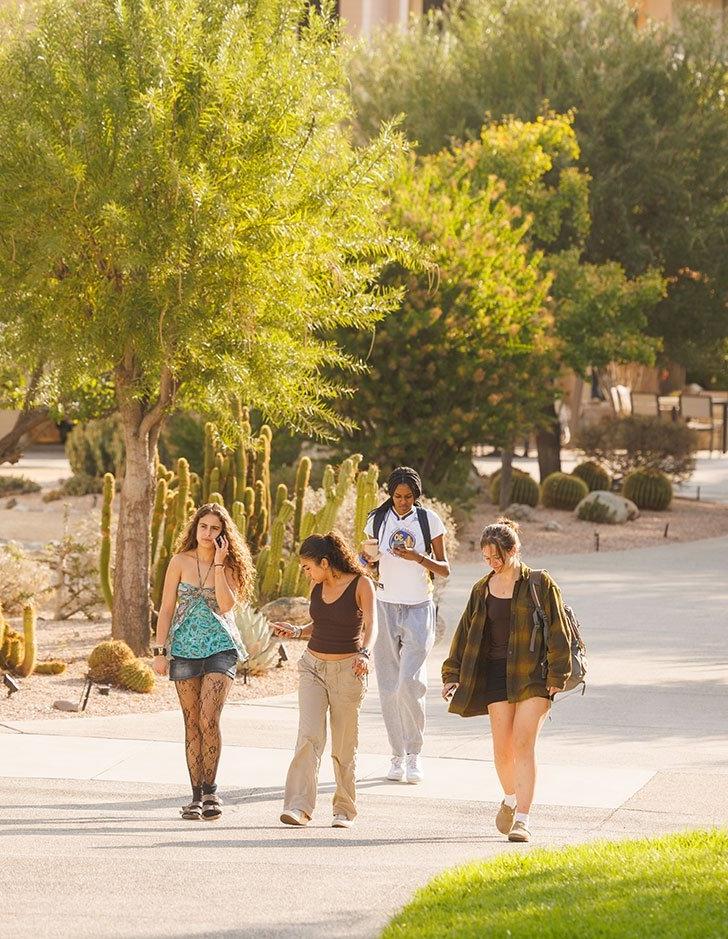 a group of students walks past the holden garden